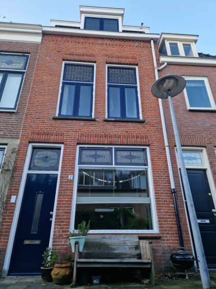 Frontdoor with bench, in a car free cosy middle street.